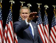 George W. Bush salutes a carefully-staged rally.